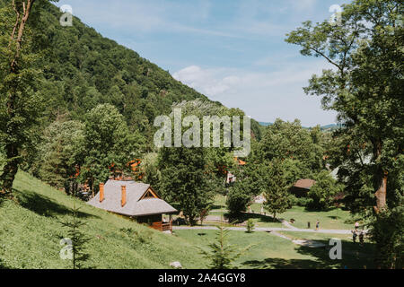 Rural landscape with lush green fields and farm house Foto Stock