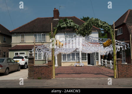 La famiglia immigrata indù decorano l'esterno suburbano della loro casa di famiglia per le figlie Ritushuddhi, anche chiamato come Ritu Kala Samskara venuta della festa rituale di cerimonia di età. Celebrando un'entrata delle ragazze nella donna dopo il menarca o la prima mestruazione. 2010S REGNO UNITO HOMER SYKES Foto Stock