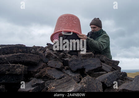 A Crofters Totegan Strathy sul punto di Caithness in Scozia pila torba hanno tagliato per il carburante invernale Foto Stock