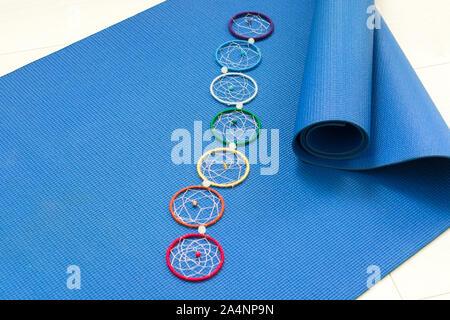 Blue materassino yoga e sette chakra decorazione. Concetto di yoga. Foto Stock