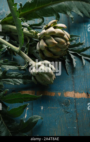 Carciofo crudo close-up su sfondo di legno Foto Stock