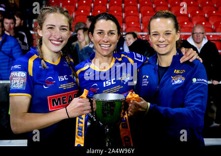 Leeds Rhino's donne Caitlin Beevers (sinistra) Courtney Hill e Lois Forsell celebrare con il trofeo dopo aver vinto il Betfred donna Super League Gran finale al totalmente Wicked Stadium, St Helens. Foto Stock