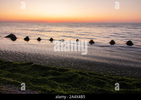 Seascape. Un delizioso alba con pietre. Foto Stock