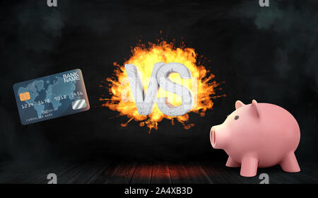 3D rendering di un calcestruzzo flaming lettere VS stand tra una carta di credito e un salvadanaio. Foto Stock