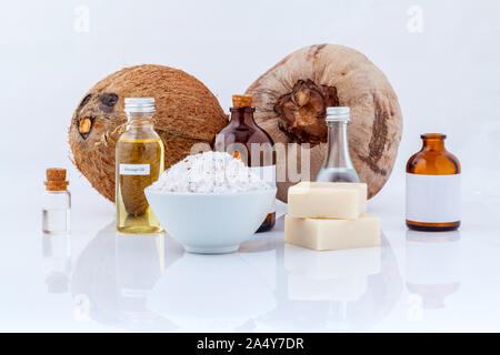 Noce di cocco Oli essenziali naturali ingredienti Spa per spazzolare ,massaggi e per la cura della pelle isolare su sfondo bianco. Foto Stock