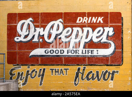 Vintage Dr. Pepper annuncio su una parete esterna del Dr Pepper Museo in un ex stabilimento che imbottigliato la bevanda analcolica a Waco, Texas Foto Stock