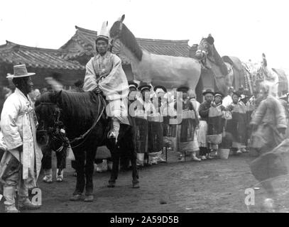 Imperatrice Myeongseong 1895 dopo assaination dal Giappone - uomo a cavallo in foregrd.; gruppo di persone in piedi di fronte a 3 cavalli in legno. Queens funerale 1890-1923 Foto Stock