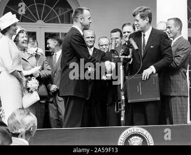 Astronauta Alan B.Shepard Jr. riceve la NASA Distinguished Service Award dal presidente degli Stati Uniti John Fitzgerald Kennedy Maggio 8, 1961, giorni dopo la sua storia facendo MR-3 volo. Shepard la moglie e madre sulla sinistra e gli altri sei astronauti Mercury sono in background. Foto Stock