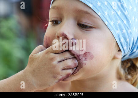 Bambina mangiare frutti di gelso Foto Stock