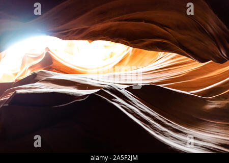 Basso angolo di vista nero scuro le ombre e la luce del cielo in upper Antelope Canyon slot con forma d'onda roccia arenaria nella pagina, Arizona Foto Stock