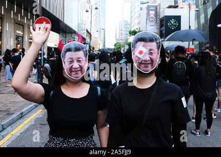 I manifestanti che indossano maschere di Xi Jingping prendere parte durante la dimostrazione.Poco dopo un mese di marzo non autorizzata è terminato, i conflitti tra la polizia e i manifestanti hanno continuato, costringendo la polizia ad utilizzare acqua di cannoni e gas lacrimogeni per disperdere i manifestanti. Con il governo anti-movimento entrando nel suo quarto mese e continuate a escalation, molti Cina-legato memorizza e business sono essendo soggetto ad atti vandalici e arson. Foto Stock