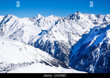 Stazione sciistica in Solden Tirolo, Austria. Belle montagne rocciose, villaggio nella valle e funivie. Soleggiata giornata invernale. Foto Stock