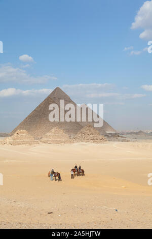 Egitto Giza, le grandi piramidi a Giza con i turisti a cavallo. Foto Stock