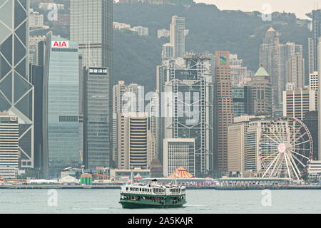 Il Traghetto Star attraversa il Victoria Harbour con lo skyline del Distretto Centrale di Hong Kong. Il Traghetto Star barche sono state per il trasporto di passeggeri da Isola di Hong Kong a Kowloon e torna dal 1888. Foto Stock