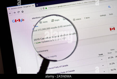 Montreal, Canada - 21 Ottobre 2019: Gazzetta del Canada Elezioni Elezioni del sito.ca su un computer portatile schermo sotto la lente di ingrandimento. Foto Stock
