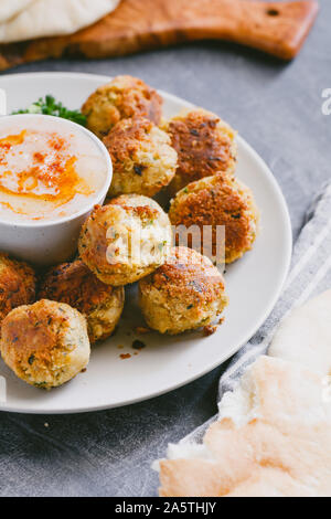 Famoso e tradizionale del Medio Oriente falafel piatto con hummus su una piastra servita. Foto Stock