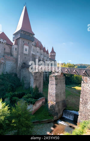 Vista del castello di Corvin o Hunyadi il castello e il fiume che scorre sotto il ponte di Hunedoara. Colpo verticale Foto Stock