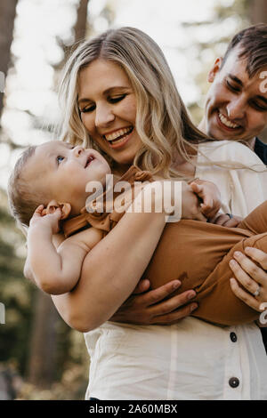 Felice madre abbraccia il suo piccolo figlio all'aperto Foto Stock