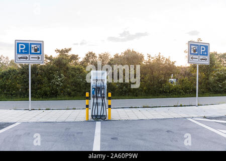 Il veicolo elettrico stazione di carica presso l'autostrada Foto Stock