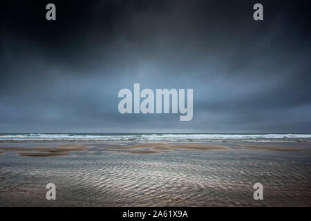 Drammatica scure nuvole temporalesche su Fistral Beach in Newquay in Cornovaglia. Foto Stock