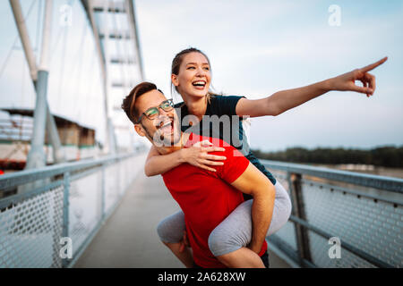 La mattina presto allenamento. Coppia felice in esecuzione attraverso il ponte Foto Stock