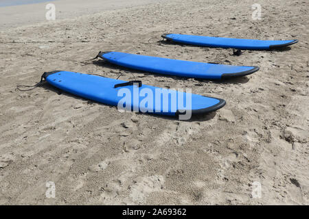 Tre blu tavole da surf sdraiato sulla spiaggia Foto Stock