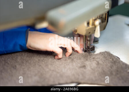 I dettagli di cucitura di pelliccia e cuoio. Produzione di calzature. Foto Stock