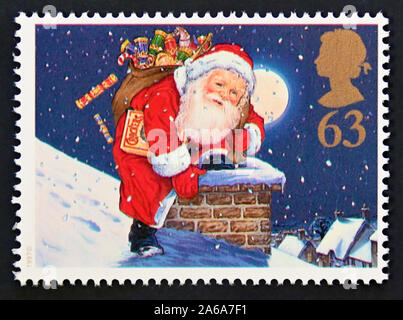 Francobollo. La Gran Bretagna. La regina Elisabetta II. Natale 1997. Centocinquantesimo anniversario della Christmas Cracker. Babbo Natale sul camino. 63p. Foto Stock