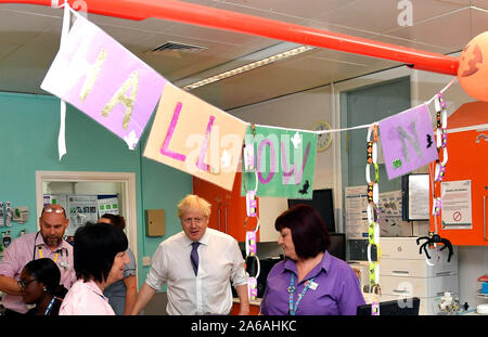 Il primo ministro Boris Johnson parla con il personale presso i bambini ward come egli visite Milton Keynes Ospedale universitario nel Buckinghamshire, Gran Bretagna il 25 ottobre 2019. Foto Stock