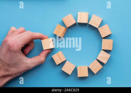 Lato la scelta di un blocco di legno da un set. Scelta aziendale concept Foto Stock