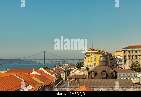 Gli edifici colorati e una vista del Ponte 25 de Abril e il fiume Tago a Lisbona, Portogallo. Foto Stock