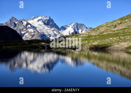 Goleon lago nelle Alpi francesi con pic di La Meije in background e in riflessione nel lago Foto Stock