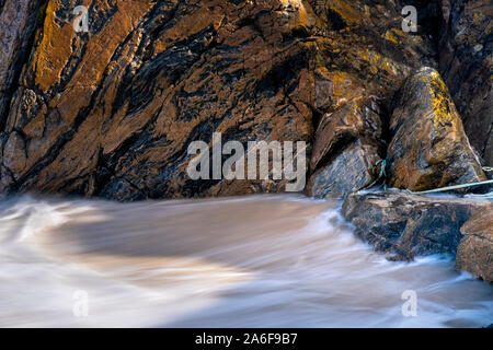 Spiaggia remota sulla riva del: Achmelvich Bay in Assynt, Sutherland nel nord ovest di Highlands scozzesi nota massiccia Lewisian gneiss boulder in primo piano Foto Stock