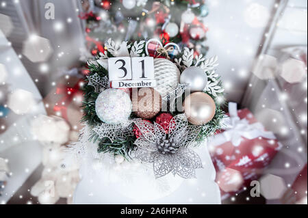 Calendario di legno con sullo sfondo di un albero di Natale con una data di Dicembre 31, un simbolo del nuovo anno Foto Stock