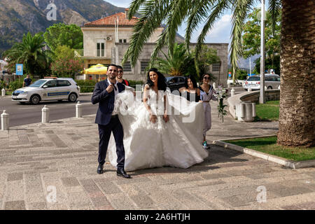 Montenegro, Sep 18, 2019: Sposa con accompagnatore a piedi una delle chiese a Cattaro Città Vecchia Foto Stock