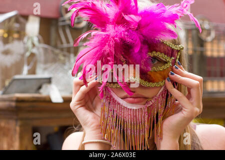 Thorp, Washington / STATI UNITI D'AMERICA - Agosto 12, 2018: giovane ragazza cerca su una masquerade mask in un negozio di antiquariato e frutta stand vicino Ellensburg, Washington. Foto Stock