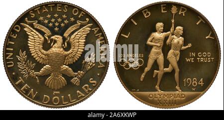 Stati Uniti golden moneta 10 dieci dollari 1984, oggetto XXIII Giochi Olimpici in Los-Angeles, eagle al di sotto di tredici stelle, maschio e femmina carryi atleti Foto Stock