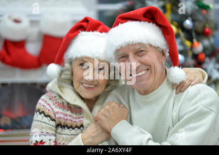 Ritratto di felice coppia senior in cappelli di Babbo Natale Foto Stock