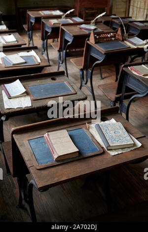 Vintage o antichi inizi XVIII secolo schoolhouse scrivanie e libri sul display a Montgomery in Alabama, Stati Uniti d'America. Foto Stock