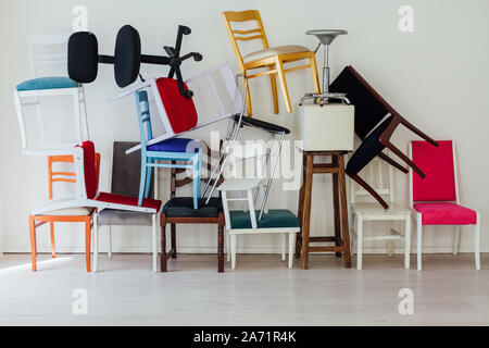 Diverse sedie multicolori all'interno della camera bianca Foto Stock