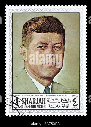 Annullato francobollo stampato da Sharjah, che mostra la pittura di Norman Rockwell, circa 1968. Foto Stock