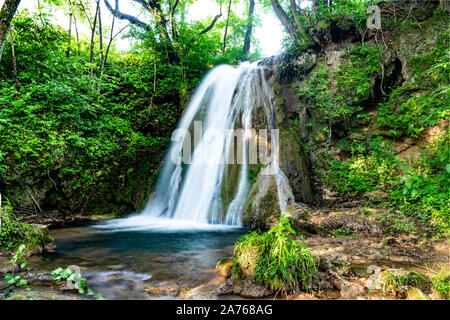 Belle cascate nel villaggio di Donji Taor, Taorska vrela. Piante verdi e moss bloom accanto all'acqua che scorre verso il basso lungo la cascata di rocce calcaree. Foto Stock