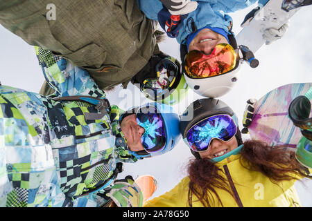 Immagine di felice snowboarder guardando giù al winter resort. Foto da sotto Foto Stock