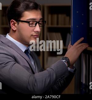 Imprenditore quasi addormentarsi a lavorare fino a tardi in ufficio Foto Stock