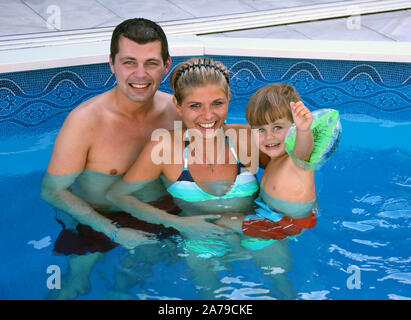 Junge Familie im Pool, Mann, Frau, tipo, 30, 35, 5, Jahre, signor:Sì Foto Stock