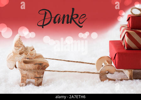 La renna, sled, neve, sfondo rosso, Danke significa Grazie Foto Stock