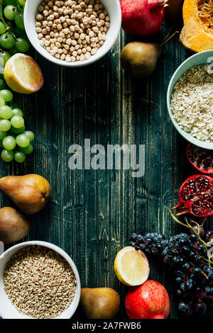 Autunnale di frutta e cereali sani sfondo, frutto tipico della stagione autunnale, coltivati biologicamente, arrotondamento ciotole piene di sano cereali di avena Foto Stock