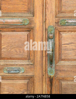 Vecchio elaborate porte in legno con hardware Foto Stock