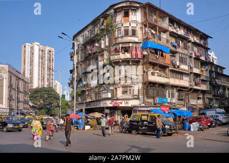 Un tipico vecchio e decrepito edificio residenziale in corrispondenza di una intersezione stradale di Grant Road, Mumbai, India, costituito da numerose proprietà individuale appartamenti Foto Stock