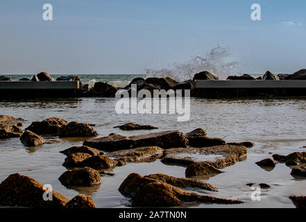 Onde che si infrangono sul pontile come il sole scende sul Golfo del Messico Foto Stock